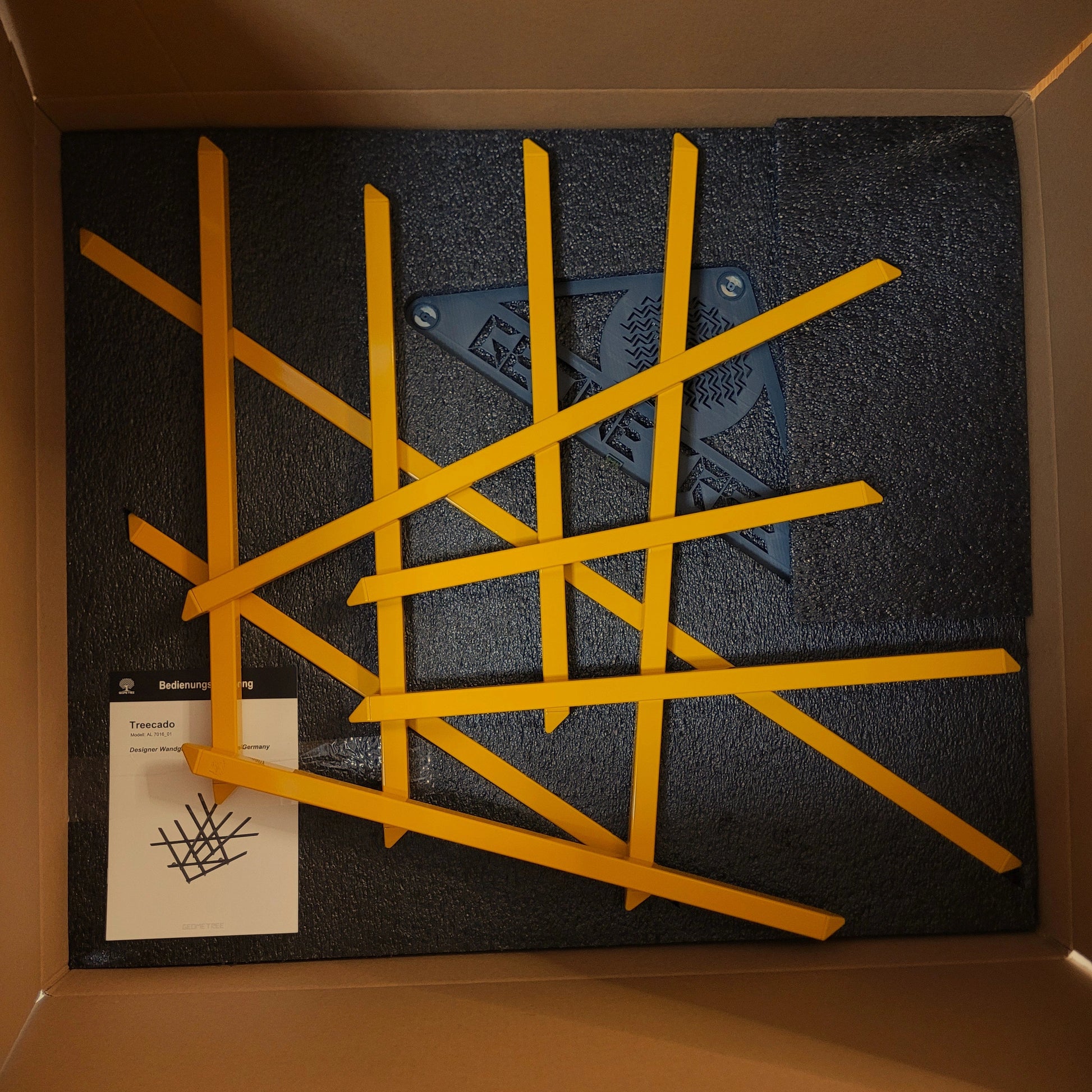 Designer Garderobe Treecado in goldgelb vormontiert und verpackt im Karton.